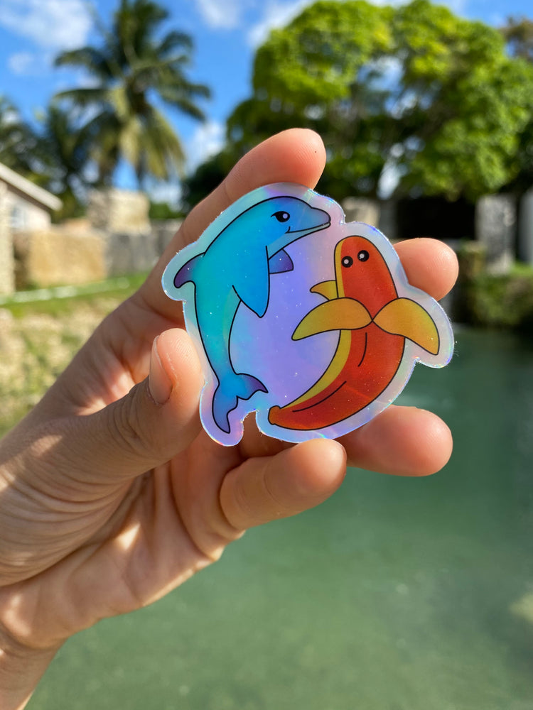 
            
                Load image into Gallery viewer, Holographic Banana Dolphin Sticker
            
        